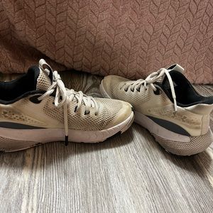 Black and white under armor running shoes